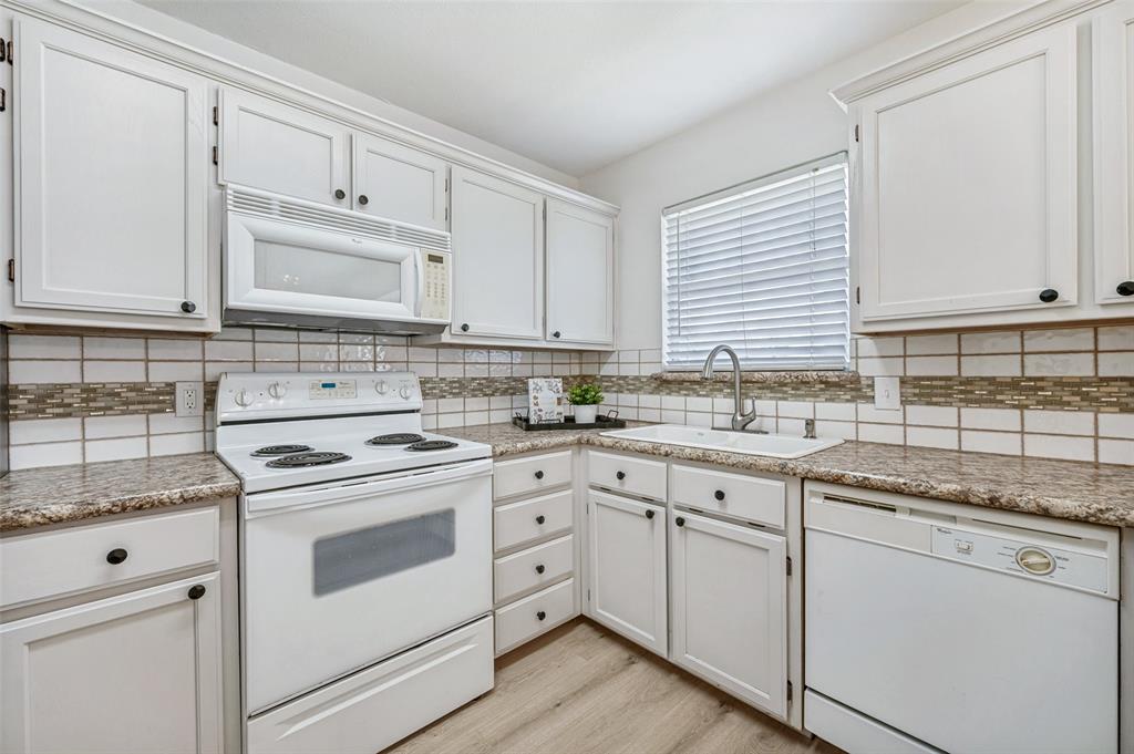 629 Concho Drive Oak Point, TX 75068 - Photo 12 of 35 a kitchen with cabinets appliances a sink and a window