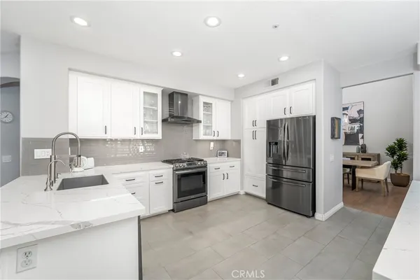 a kitchen with a refrigerator and a sink
