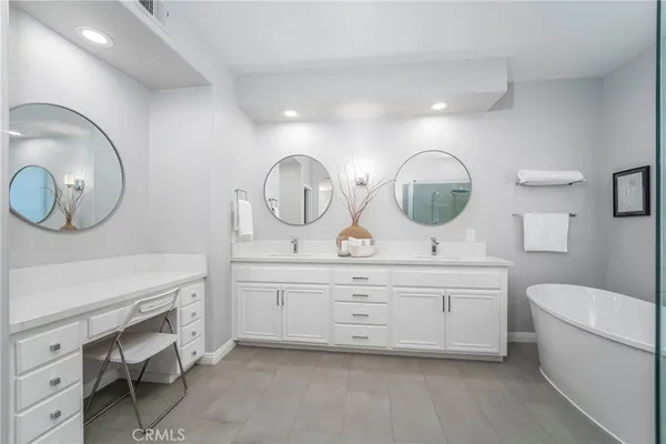 a view of a double vanity sink mirror and toilet