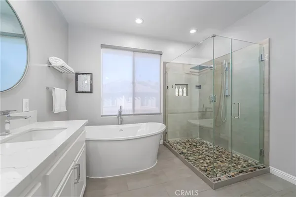 a bathroom with a bathtub a sink and a shower