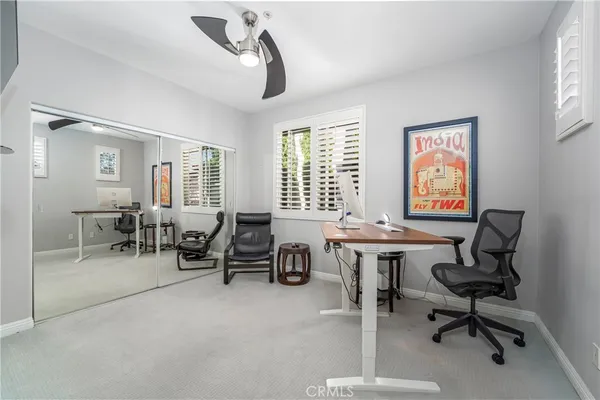 a view of a livingroom with workspace and a window