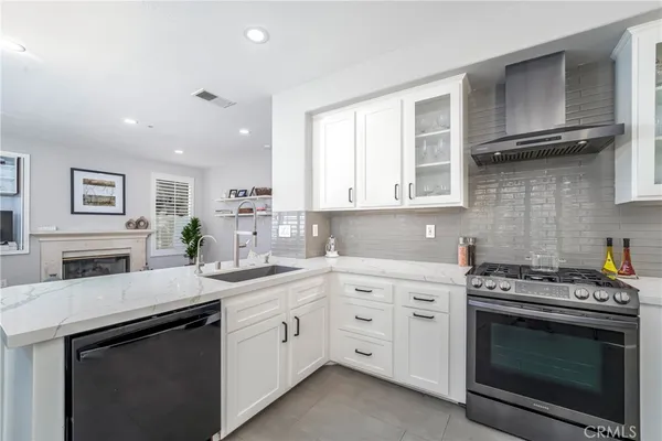 a kitchen with white cabinets stainless steel appliances and sink