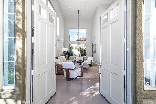 a view of a hallway with living room and dining room view