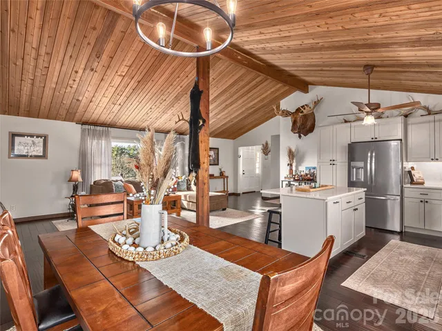 a living room with furniture and kitchen view