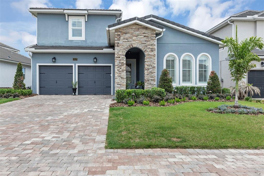 16136 Volterra Point Bella Collina, FL 34756 - Photo 1 of 64 a front view of a house with garden and garage