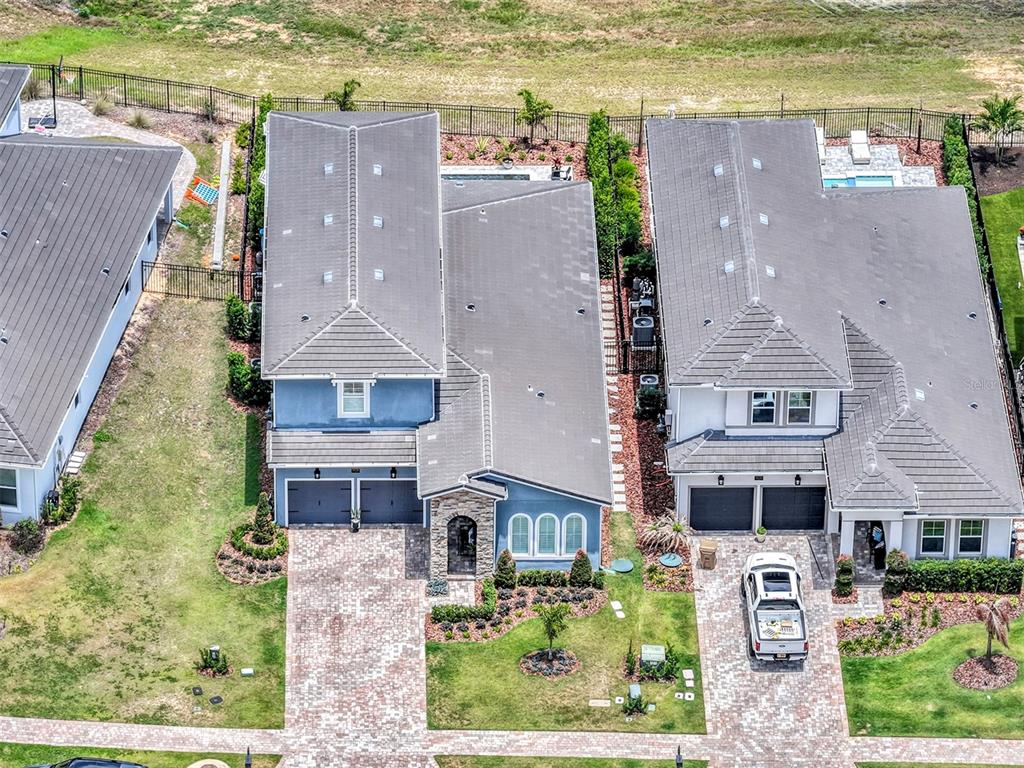 16136 Volterra Point Bella Collina, FL 34756 - Photo 54 of 64 an aerial view of residential houses with outdoor space and swimming pool