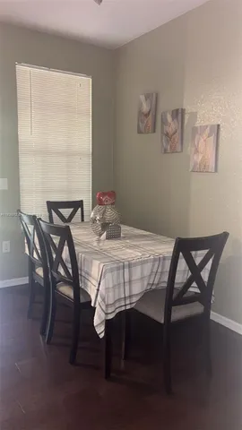 a living room with furniture and a pool table