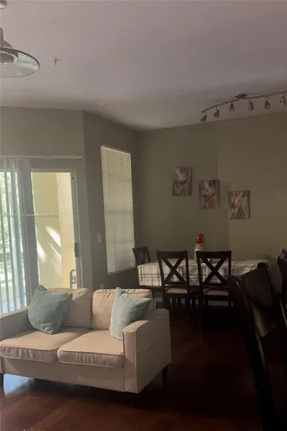 a living room with furniture and a floor to ceiling window