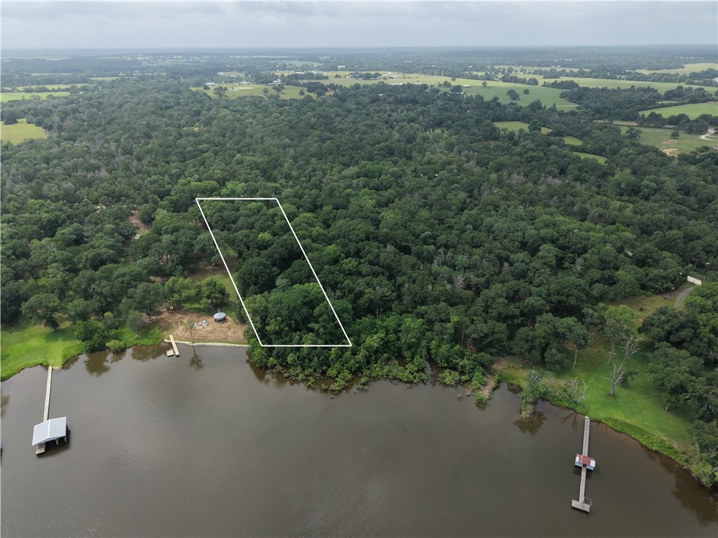 9141 Clyde Acord Road, Unit LOT 436 Franklin, TX 77856 - Photo 4 of 6 an aerial view of a house with a yard and lake view