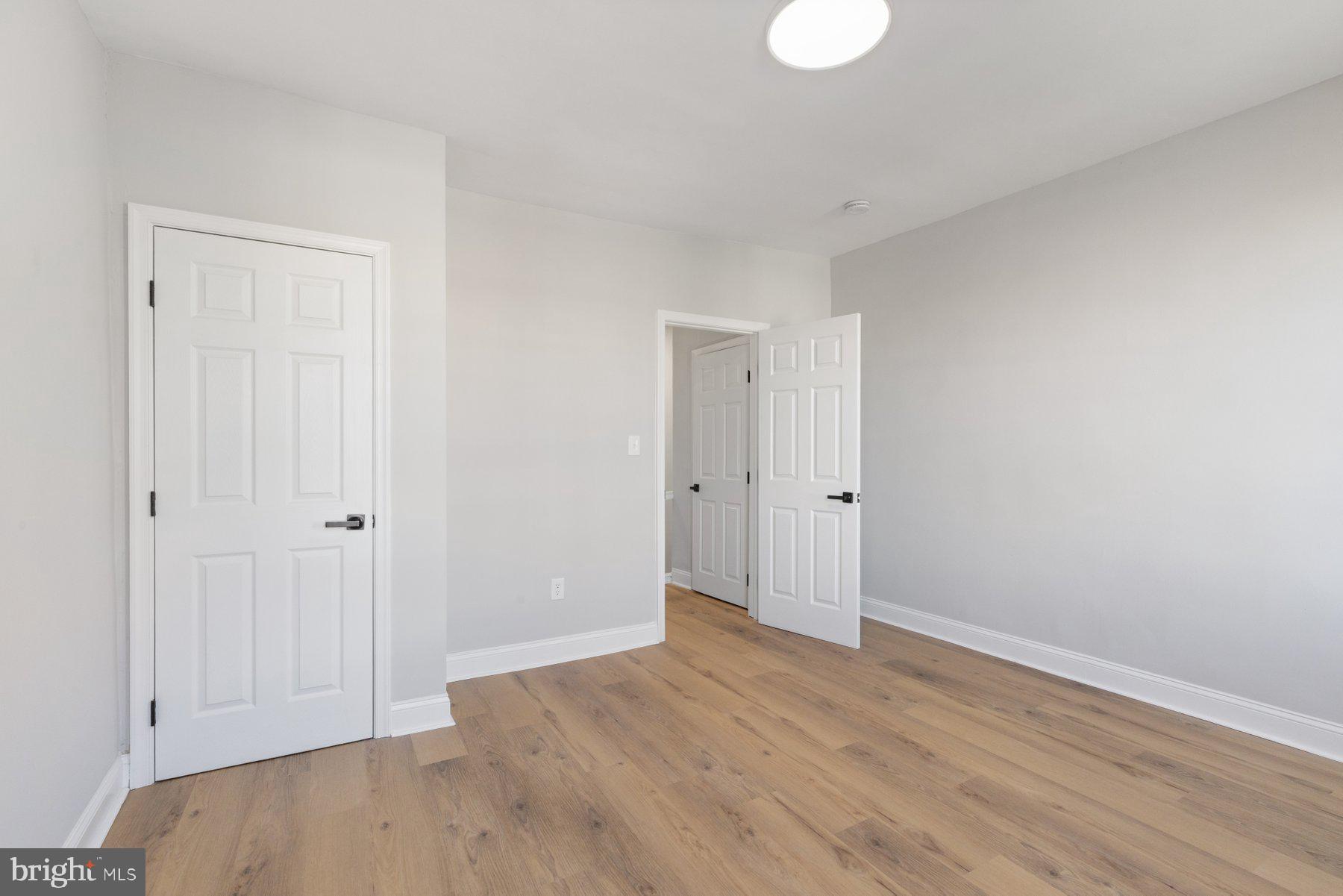 653 Bartlett Avenue Baltimore, MD 21218 - Photo 18 of 39 a view of an empty room with wooden floor