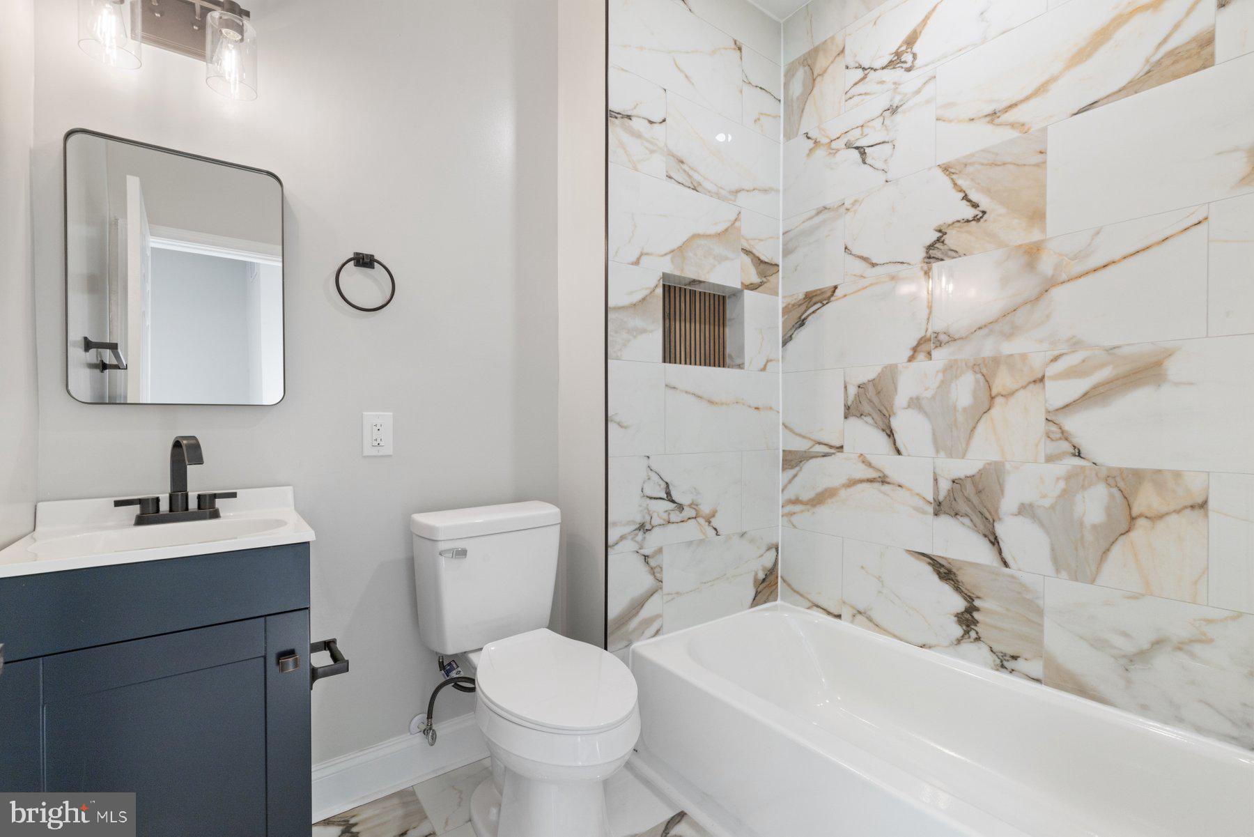 653 Bartlett Avenue Baltimore, MD 21218 - Photo 24 of 39 a bathroom with a sink toilet and mirror