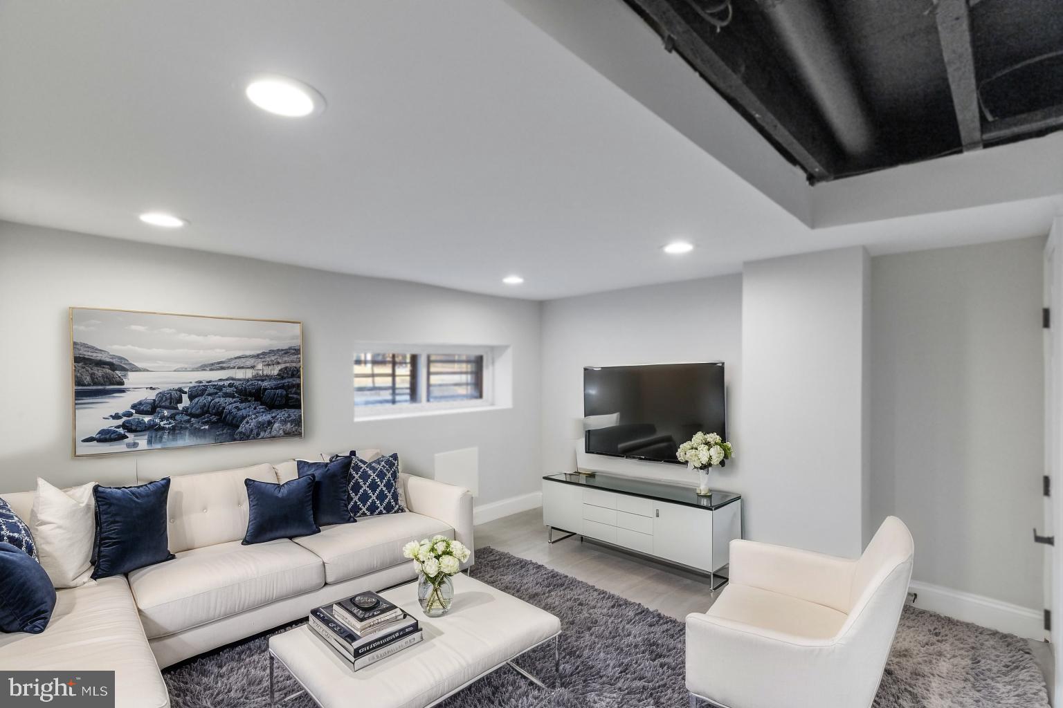 653 Bartlett Avenue Baltimore, MD 21218 - Photo 26 of 39 a living room with furniture and a flat screen tv