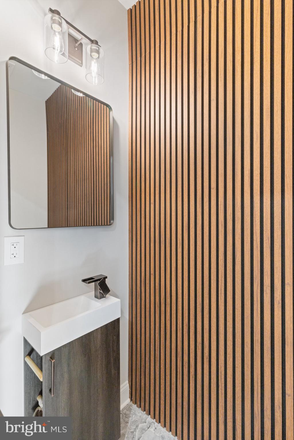 653 Bartlett Avenue Baltimore, MD 21218 - Photo 7 of 39 a bathroom with a sink and a mirror