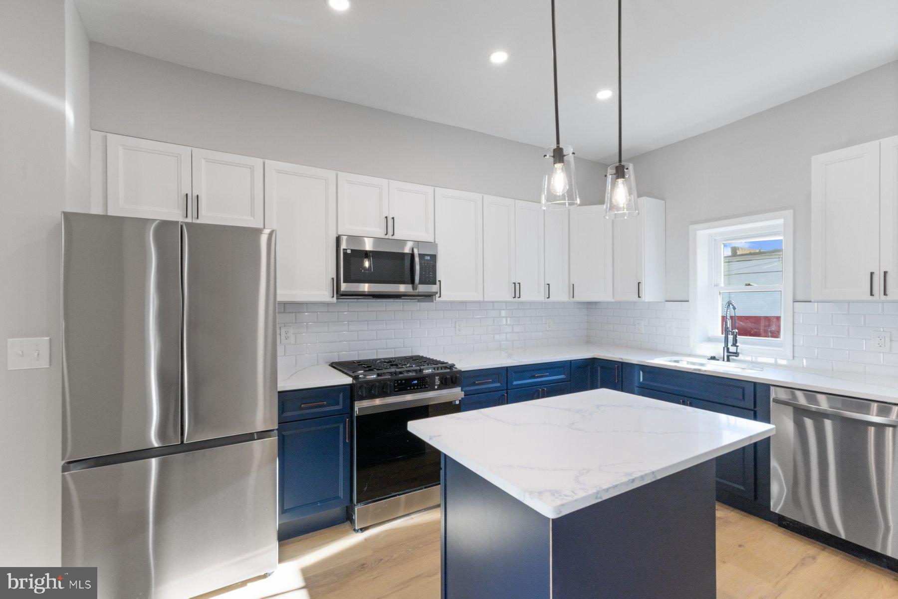 653 Bartlett Avenue Baltimore, MD 21218 - Photo 9 of 39 a kitchen with stainless steel appliances a stove a refrigerator a sink and a refrigerator