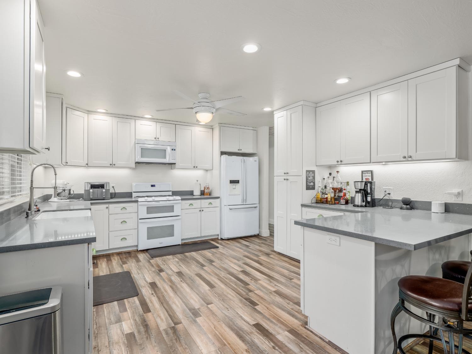 468 Burgan Avenue Clovis, CA 93611 - Photo 11 of 24 a kitchen with granite countertop white cabinets and white appliances