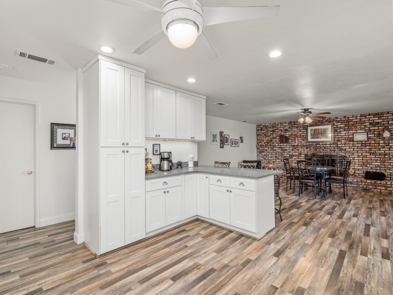 468 Burgan Avenue Clovis, CA 93611 - Photo 13 of 24 a kitchen with cabinets and wooden floor