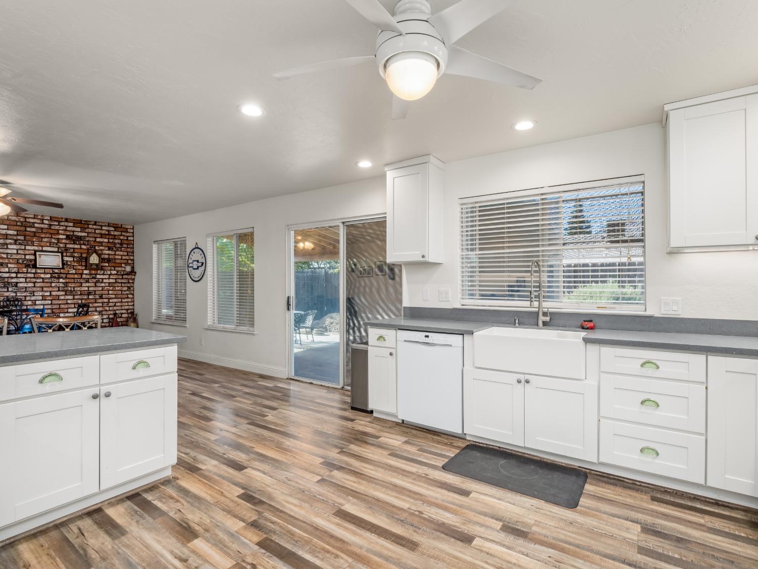 468 Burgan Avenue Clovis, CA 93611 - Photo 14 of 24 a large kitchen with cabinets wooden floor and a window
