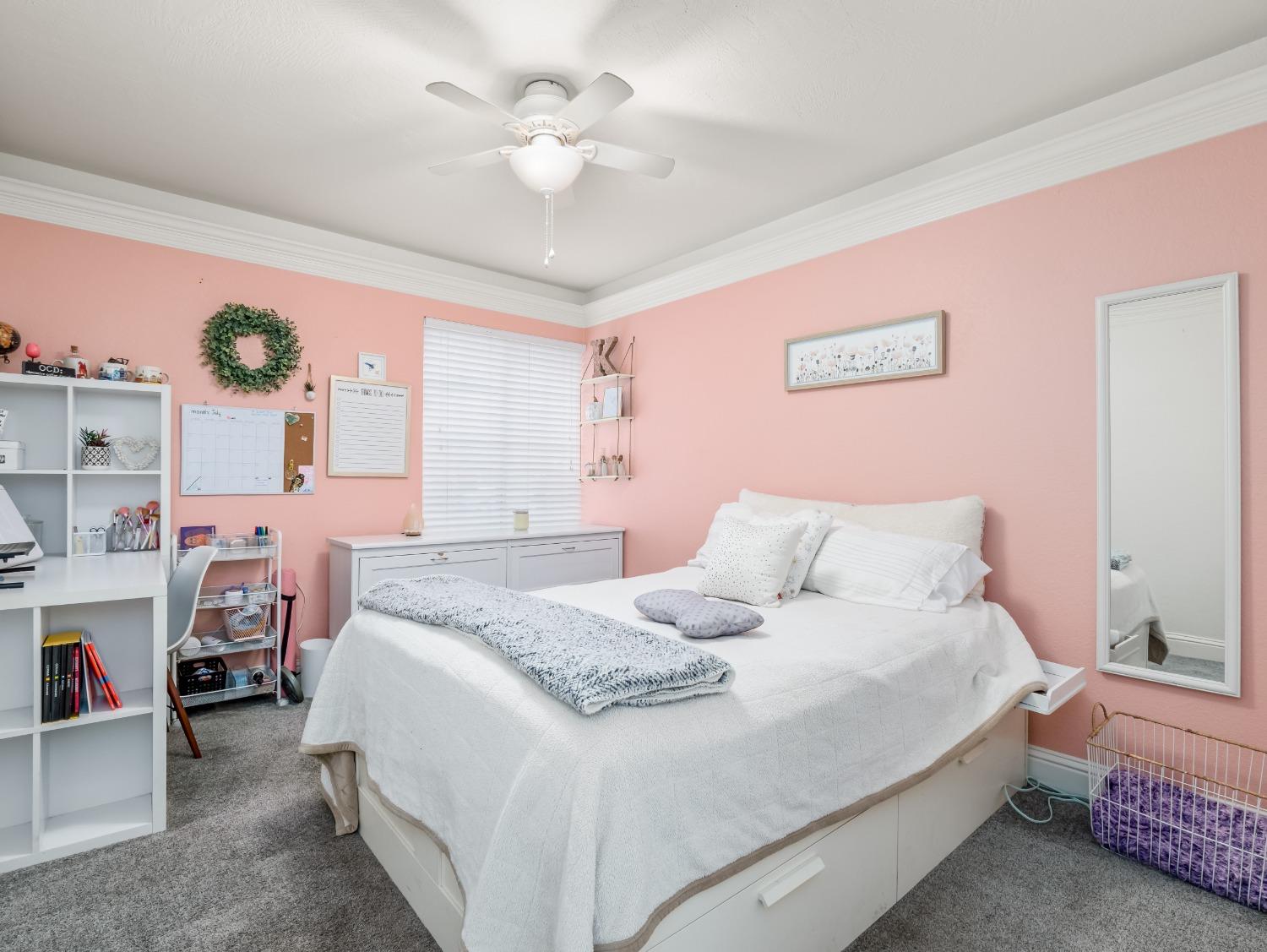 468 Burgan Avenue Clovis, CA 93611 - Photo 18 of 24 a bedroom with a bed and a chandelier