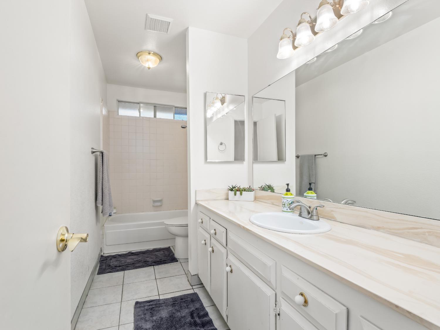 468 Burgan Avenue Clovis, CA 93611 - Photo 20 of 24 a spacious bathroom with a double vanity sink a mirror and a bathtub
