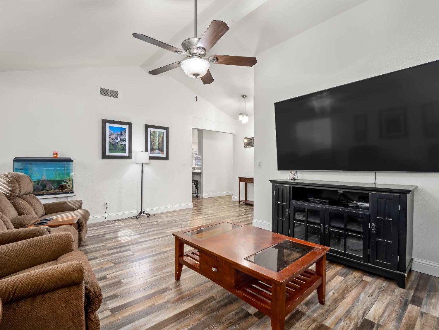 468 Burgan Avenue Clovis, CA 93611 - Photo 7 of 24 a living room with furniture and a flat screen tv