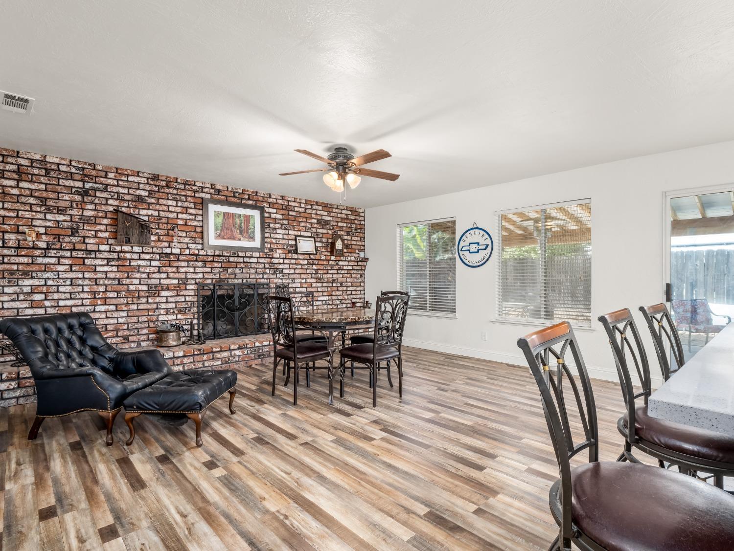 468 Burgan Avenue Clovis, CA 93611 - Photo 8 of 24 a dining room with furniture a rug and wooden floor