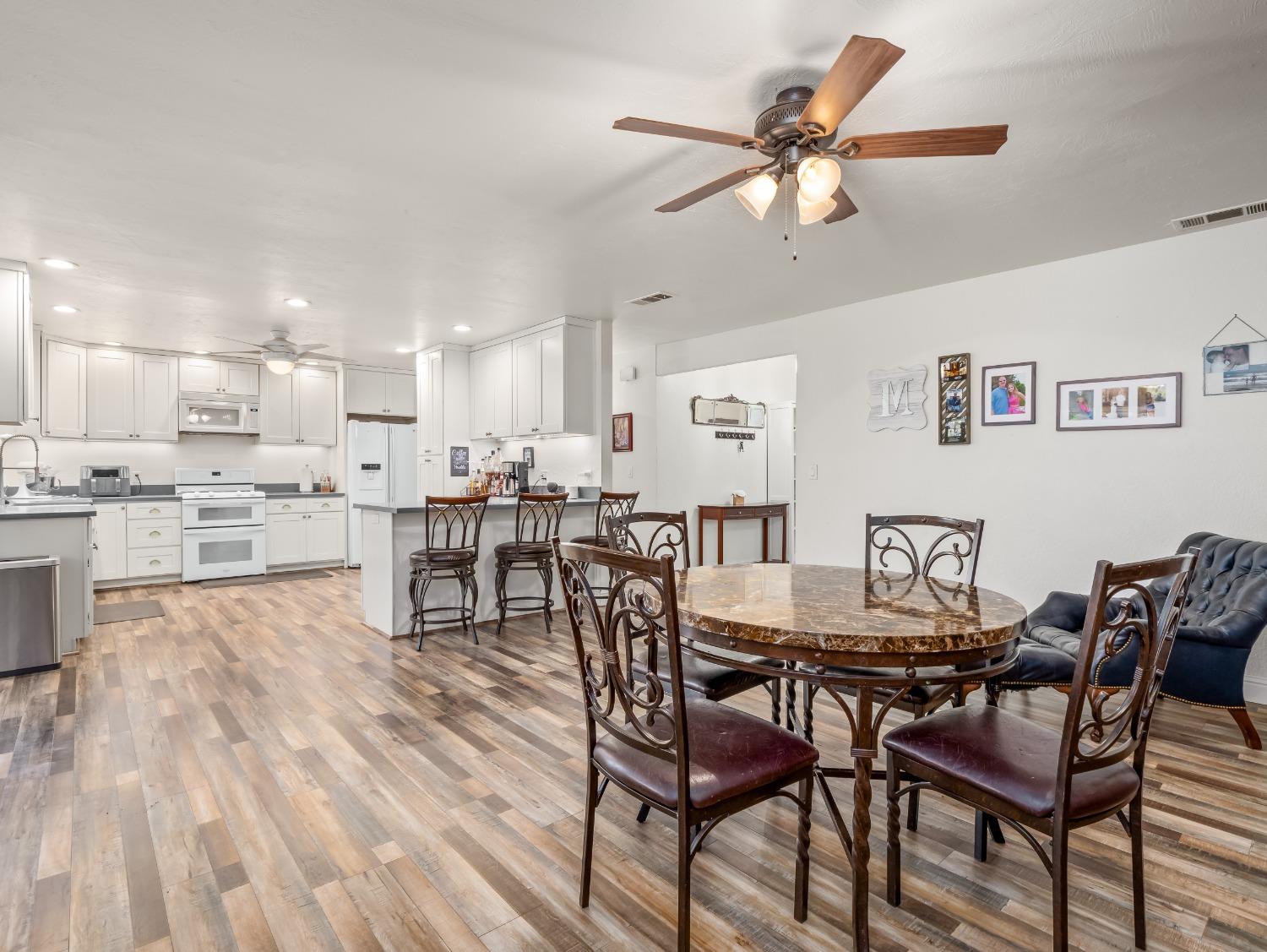 468 Burgan Avenue Clovis, CA 93611 - Photo 9 of 24 a view of a dining room with furniture and a wooden floor