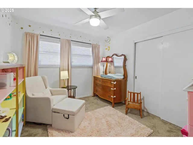 a living room with furniture a flat screen tv and a window