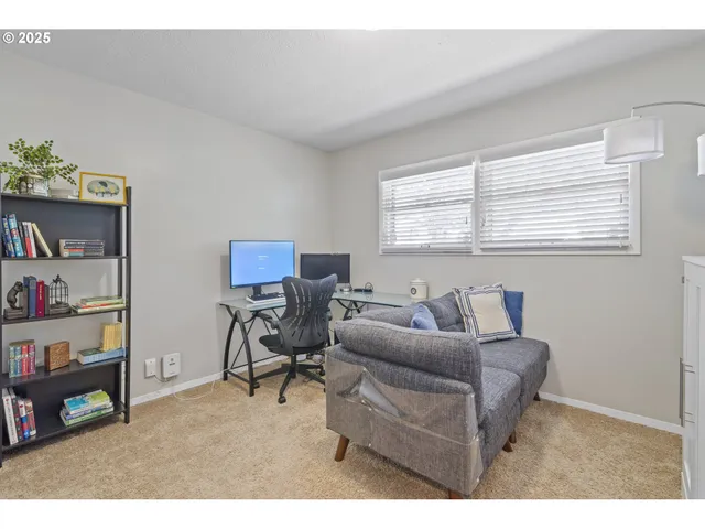 a living room with furniture and a book shelf