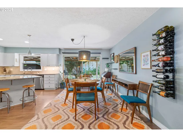 a living room with lots of furniture and kitchen view