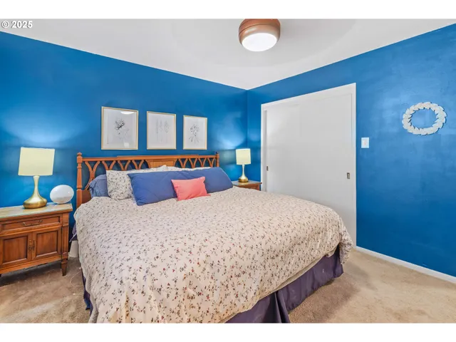 a bedroom with a bed and a lamp