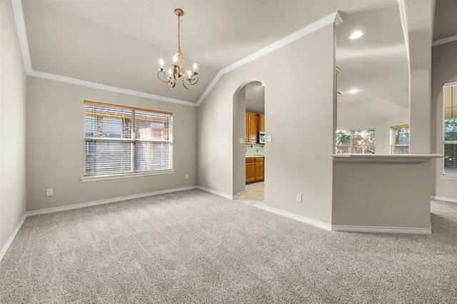 a large kitchen with kitchen island granite countertop a large window and a sink