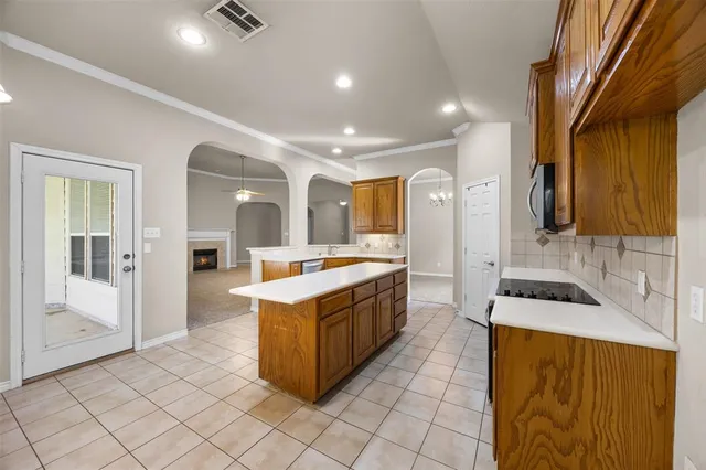 a large kitchen with stainless steel appliances granite countertop a sink and cabinets