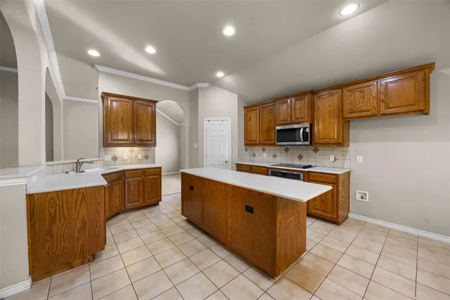 a kitchen with microwave cabinets and a stove top oven