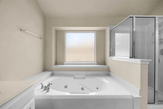 a large bathroom with a glass door shower a sink and a mirror