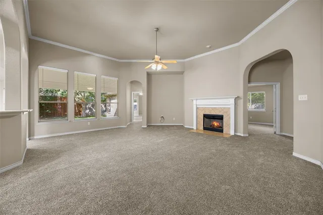 a view of an empty room with a fireplace and a window