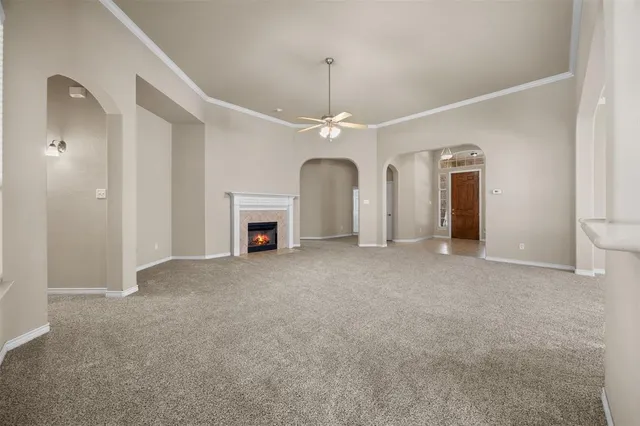 a view of empty room with fireplace and fan