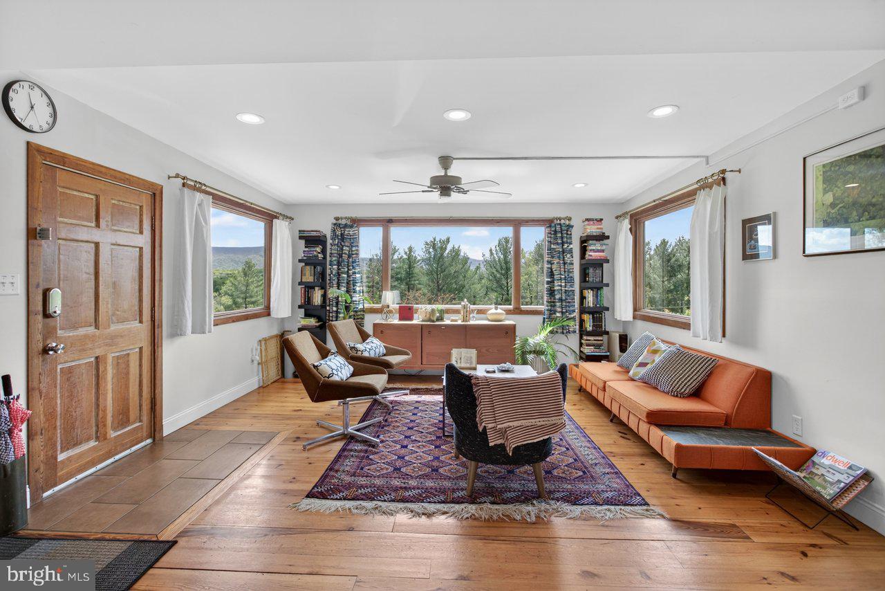 6261 South Page Valley Road Luray, VA 22835 - Photo 5 of 55 a living room with furniture large windows and wooden floor