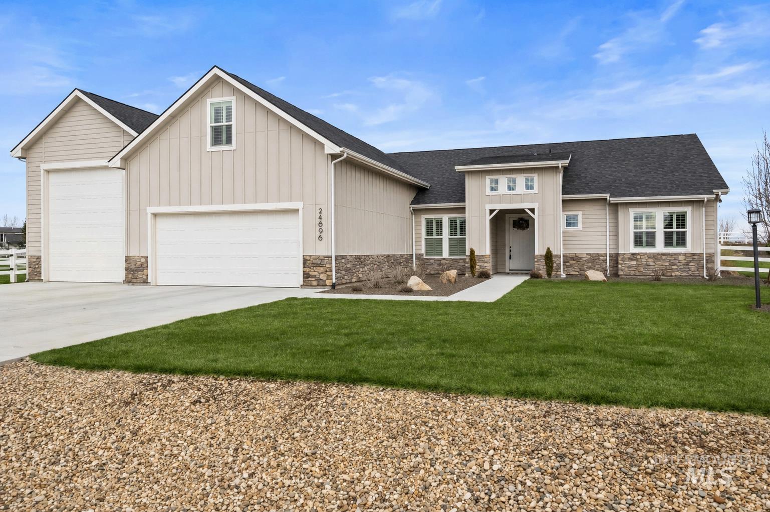 24696 Regal Road Middleton, ID 83644 - Photo 2 of 24 Single-story residence featuring light-toned siding, a dark shingle roof, and stone facade accents