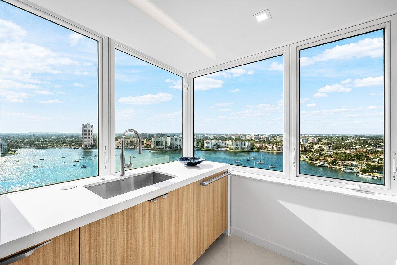 550 South Ocean Boulevard, Unit 2207 Boca Raton, FL 33432 - Photo 11 of 42 a open kitchen with kitchen island a large window and a large window