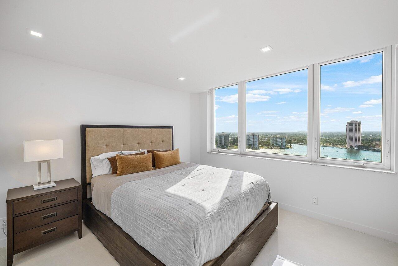 550 South Ocean Boulevard, Unit 2207 Boca Raton, FL 33432 - Photo 22 of 42 a bedroom with a large bed and a large window