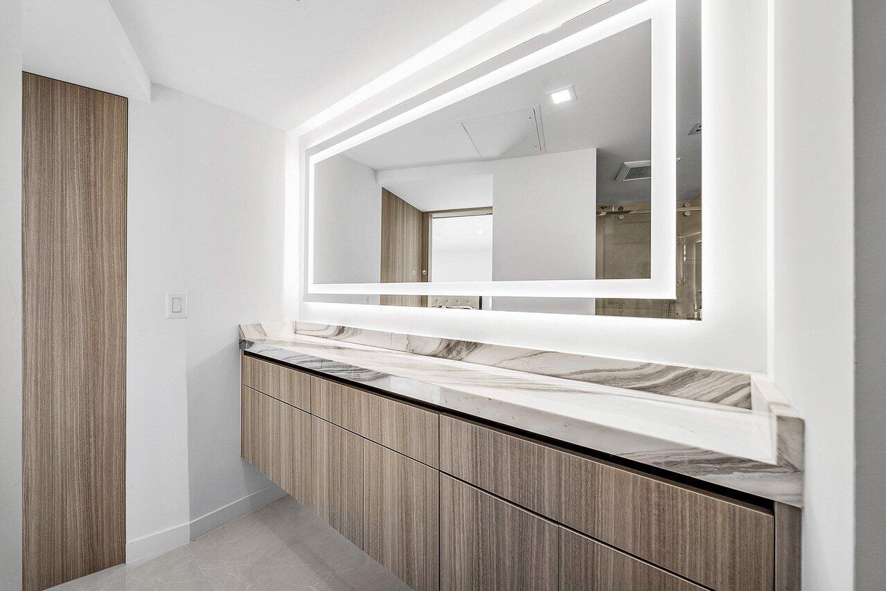 550 South Ocean Boulevard, Unit 2207 Boca Raton, FL 33432 - Photo 25 of 42 a bathroom with a granite countertop sink and a mirror