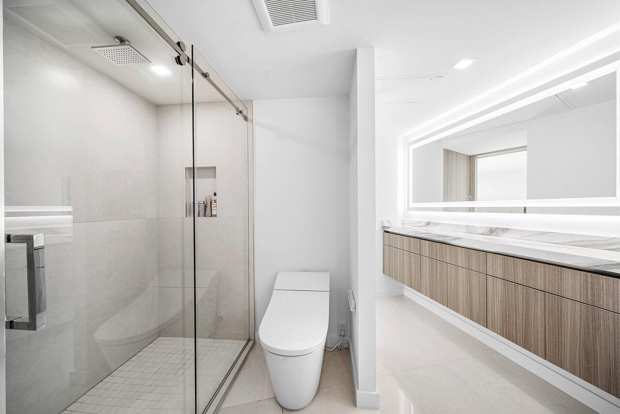 550 South Ocean Boulevard, Unit 2207 Boca Raton, FL 33432 - Photo 26 of 42 a bathroom with a toilet sink and shower