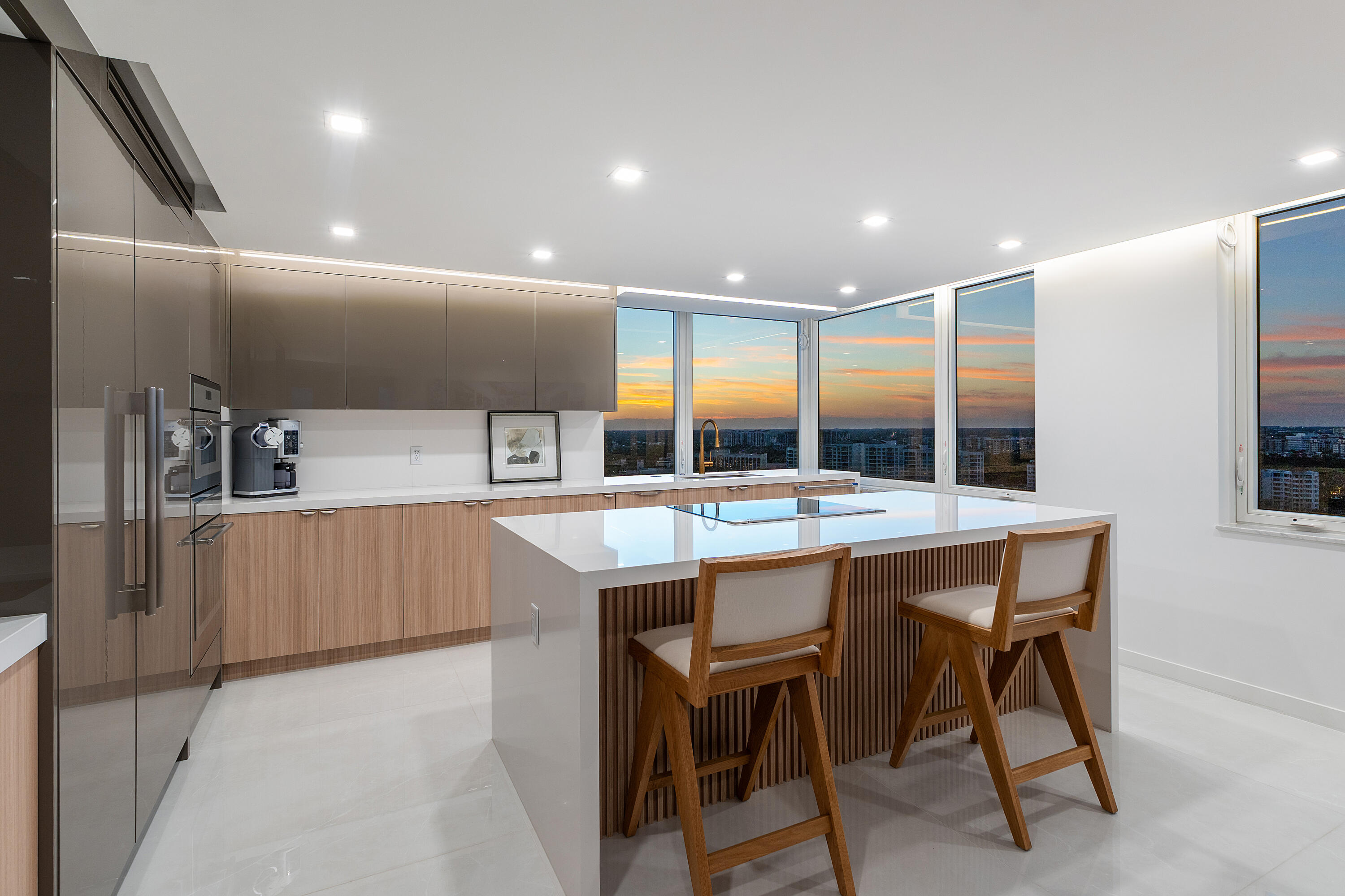 550 South Ocean Boulevard, Unit 2207 Boca Raton, FL 33432 - Photo 30 of 42 a kitchen with stainless steel appliances kitchen island granite countertop a table chairs sink and cabinets