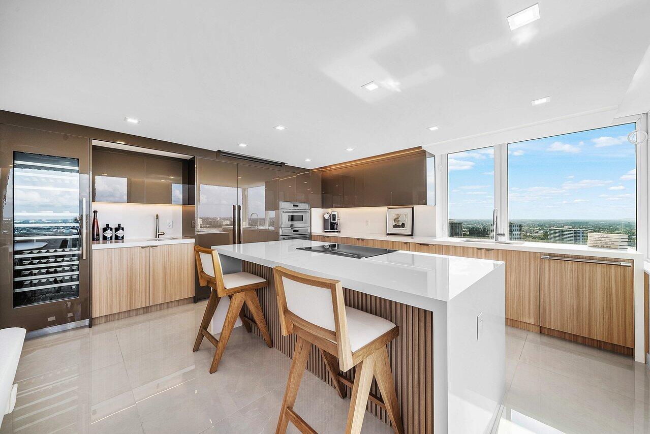 550 South Ocean Boulevard, Unit 2207 Boca Raton, FL 33432 - Photo 4 of 42 a kitchen with a sink a stove a refrigerator and cabinets