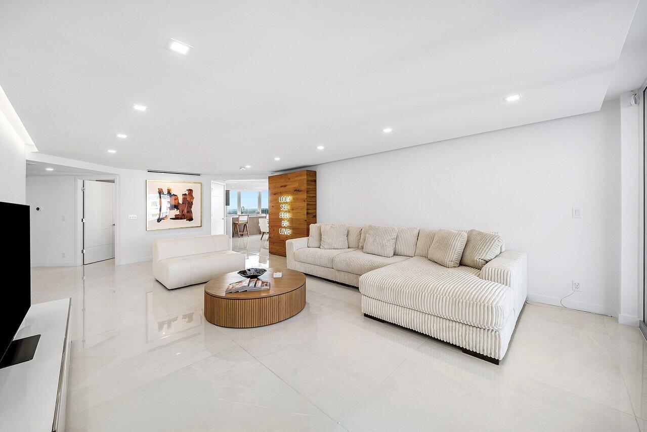 550 South Ocean Boulevard, Unit 2207 Boca Raton, FL 33432 - Photo 10 of 42 a living room with furniture a air conditioner and a flat screen tv