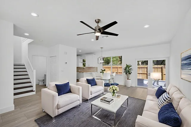 a living room with furniture and a wooden floor