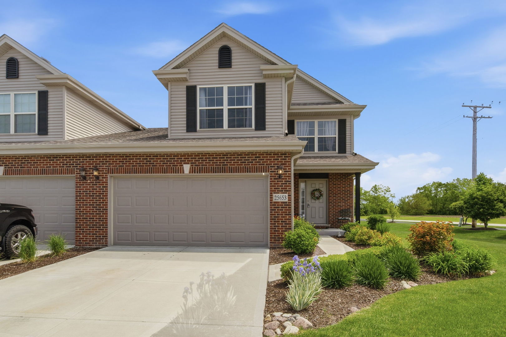25653 South Riley Erin Road Manhattan, IL 60442 - Photo 1 of 1 a front view of a house with garden