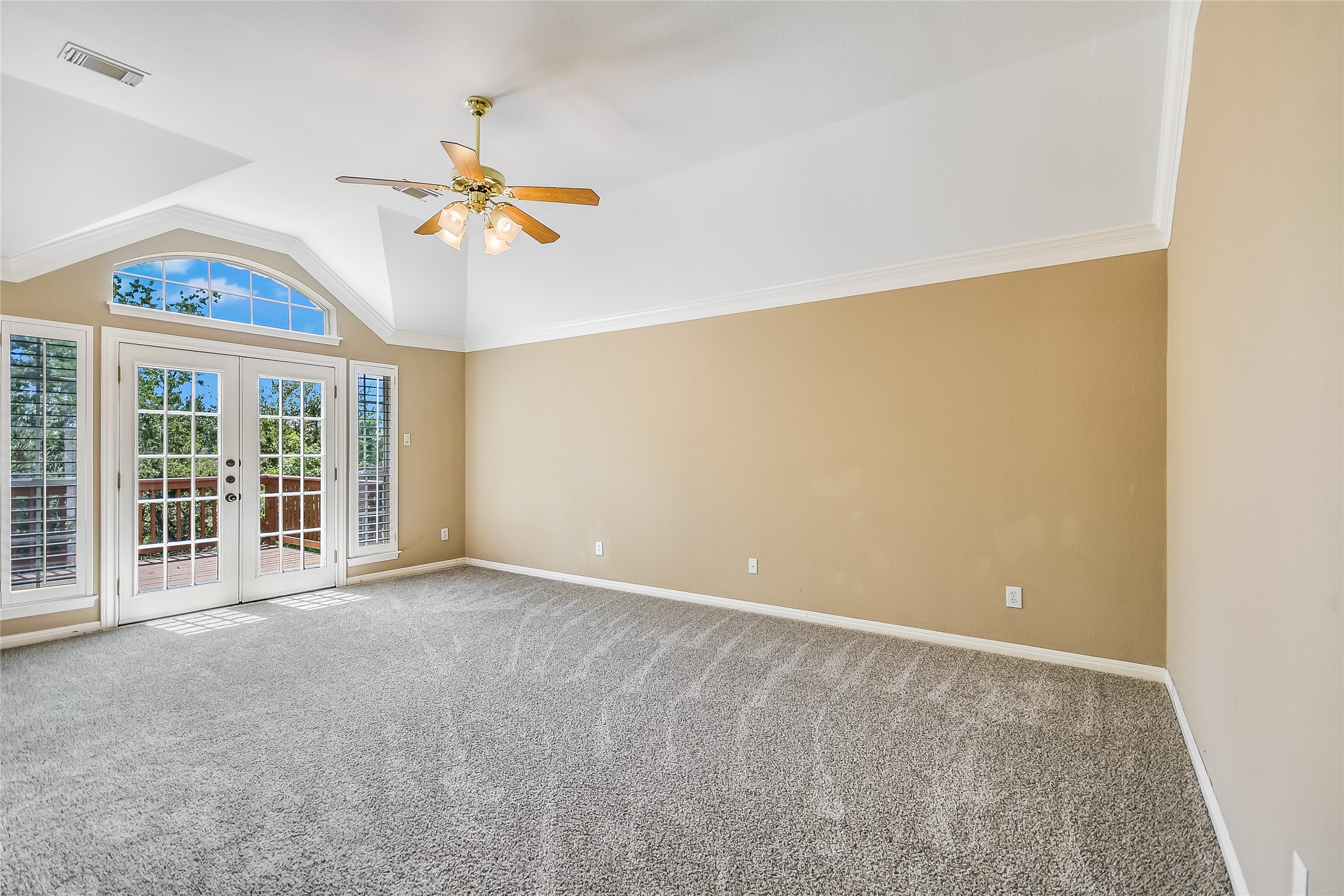 12935 Brigham Drive Austin, TX 78732 - Photo 18 of 35 Primary Bedroom - features high ceilings, crown molding, and French doors leading to second story deck. The views area amazing!