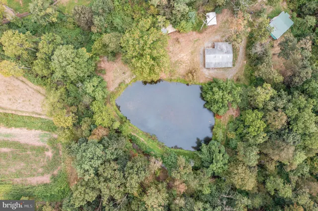 an aerial view of a house with yard and outdoor seating