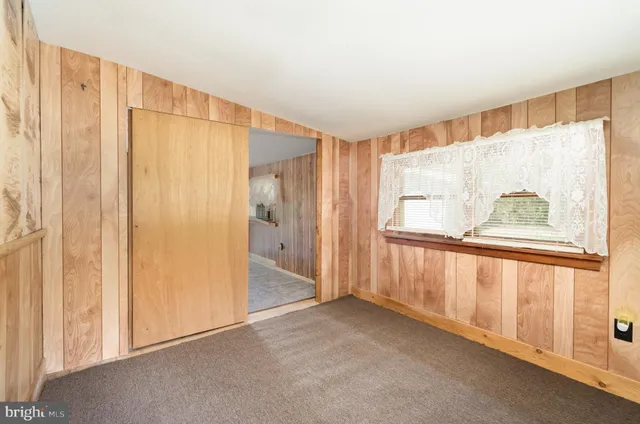 a spacious bedroom with a large bed and a large window